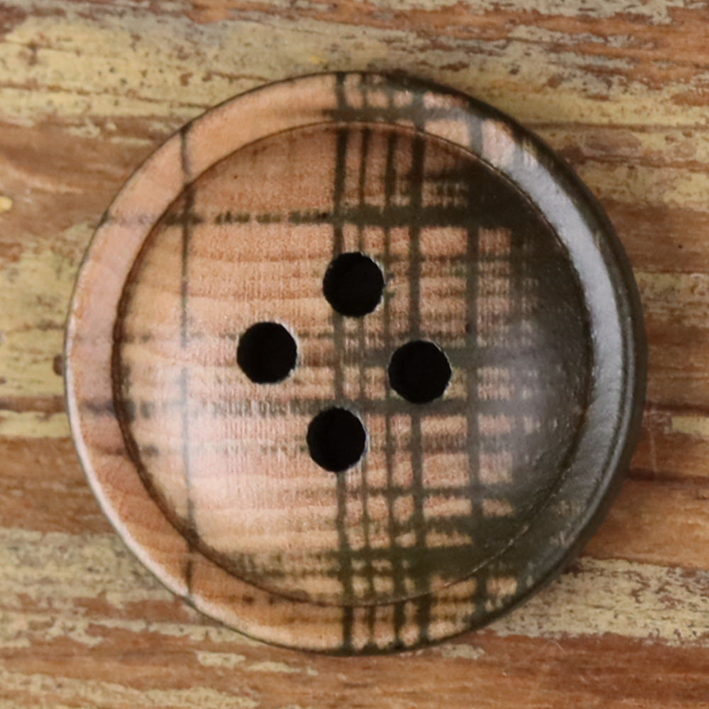 4-hole round button close-up, beige plaid fabric with four black holes