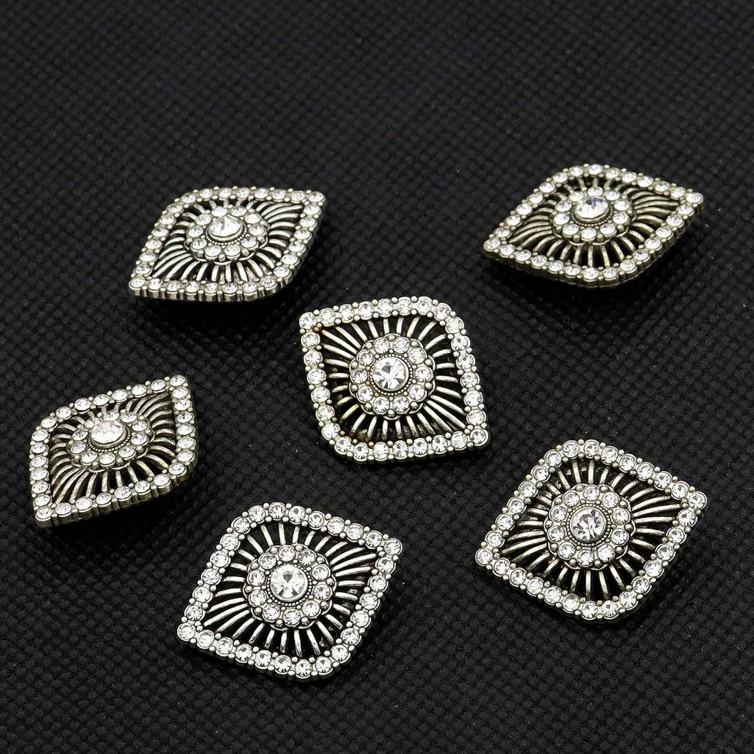 Antique silver eye-shaped rhinestone shank button with ornate sunburst center and border stones
