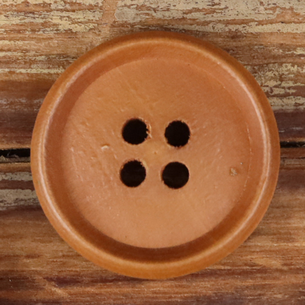 Brown round wood button with four holes, close-up