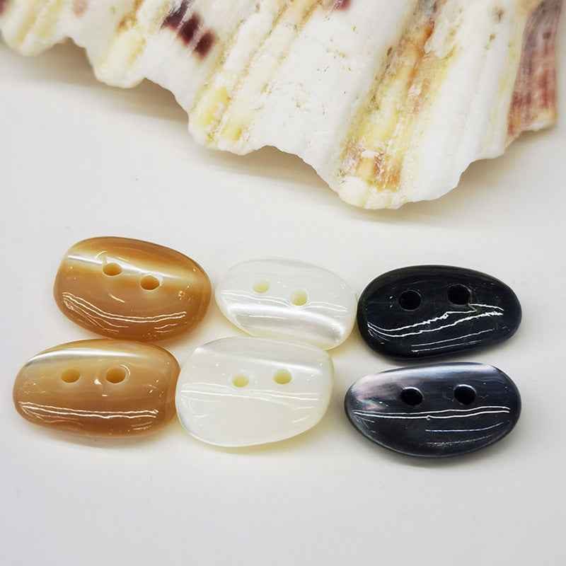Irregular mother-of-pearl shell button, tan with two holes, glossy finish