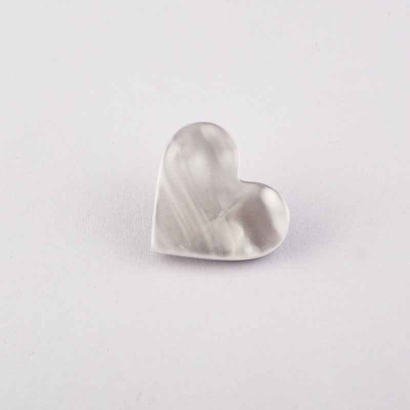 White flat heart button with metal shank, glossy front