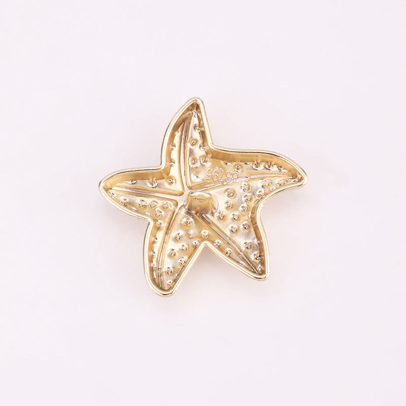 Light gold puffy starfish metal shank button back view with loop prong