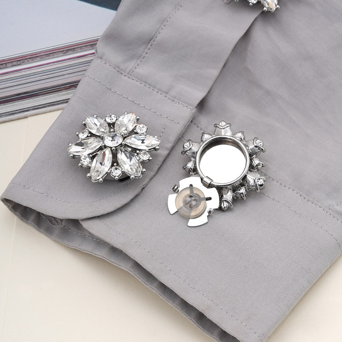 Silver crystal flower clamp buttons with ornate metal petals and round snap backs