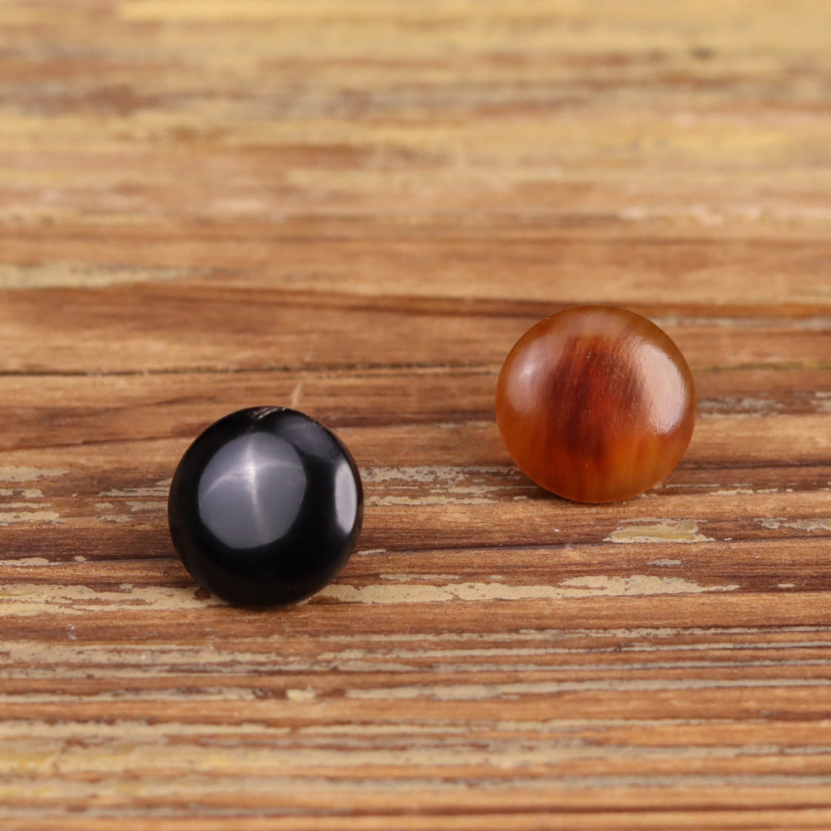 Round horn buttons, black and dark brown domed fronts with subtle marbling