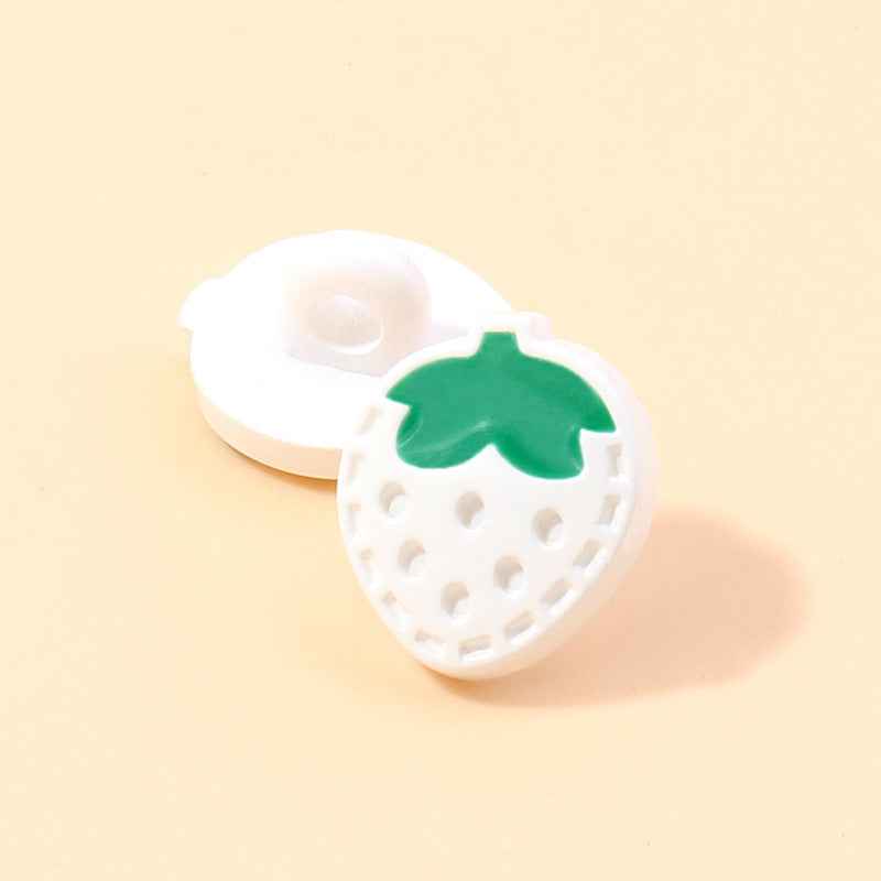 White strawberry-shaped plastic shank button with green leaf and raised dots