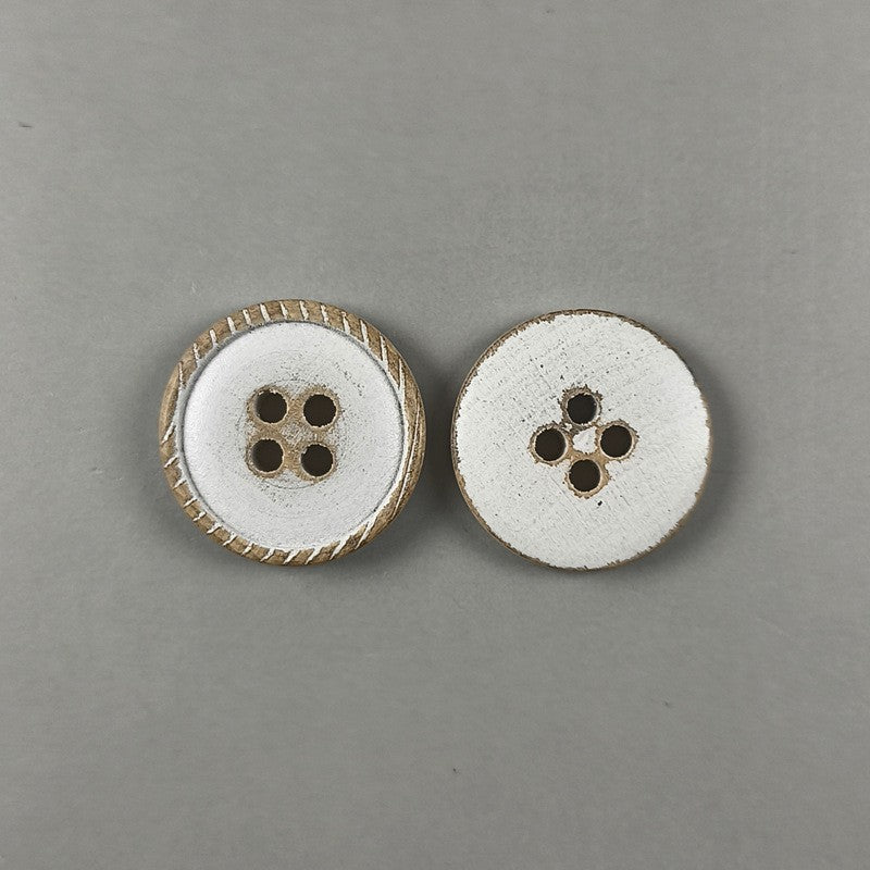 Two white round flat 4-hole wood buttons with distressed brown rims