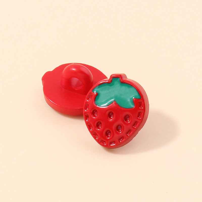 Red strawberry-shaped plastic shank button with green leaf and white dot holes
