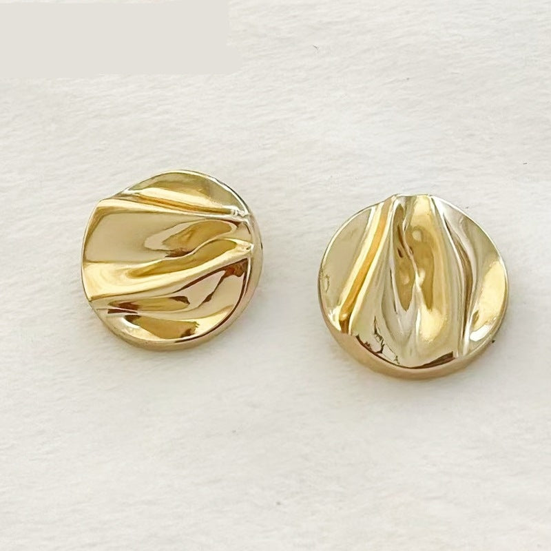 Gold wave pattern metal shank buttons—two front views with ridged swirls
