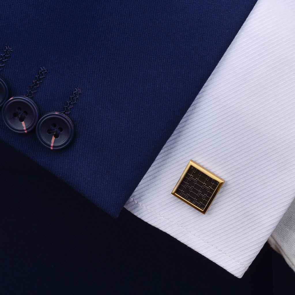 Antique bronze square cufflinks with engraved geometric pattern on dark panels
