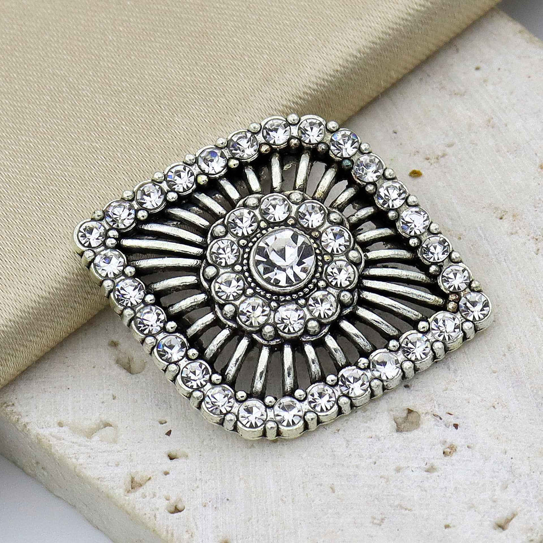 Antique silver eye-shaped rhinestone shank button with ornate sunburst center and border stones