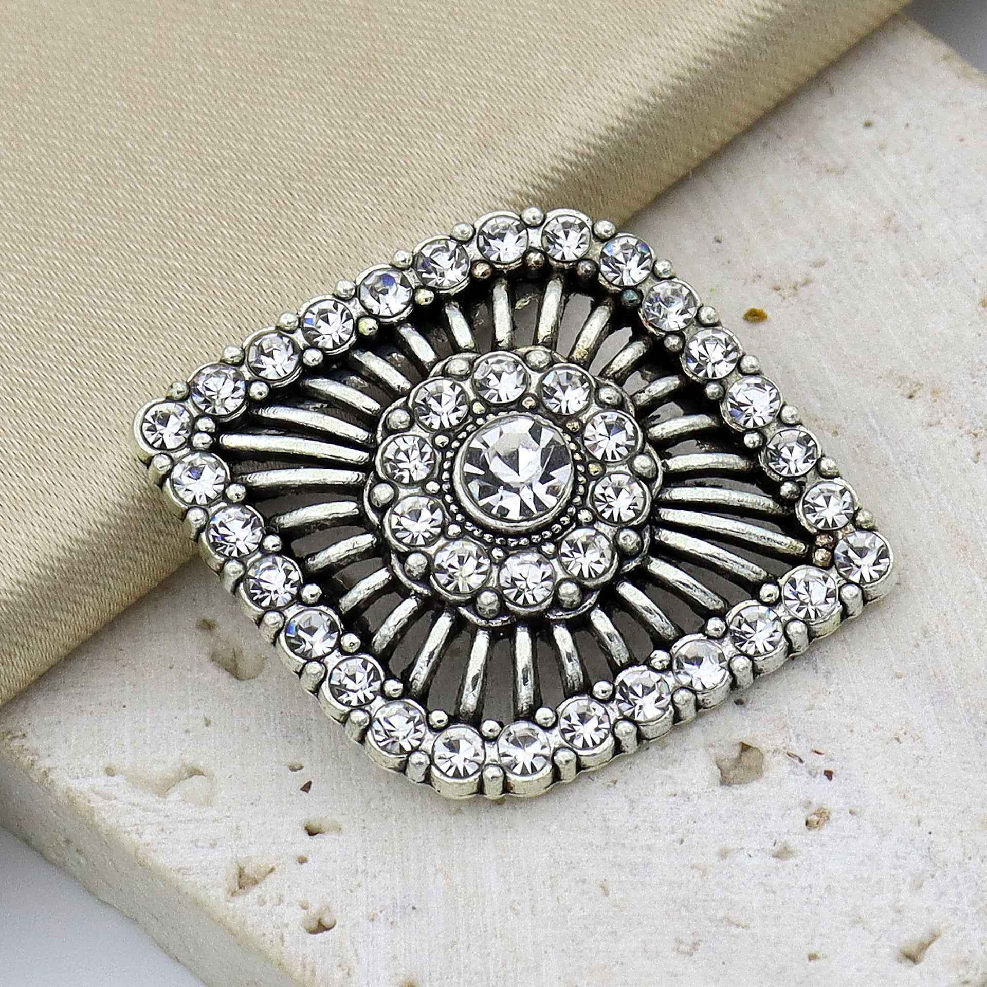 Antique silver rhinestone shank button with round crystal center and radiating prong design