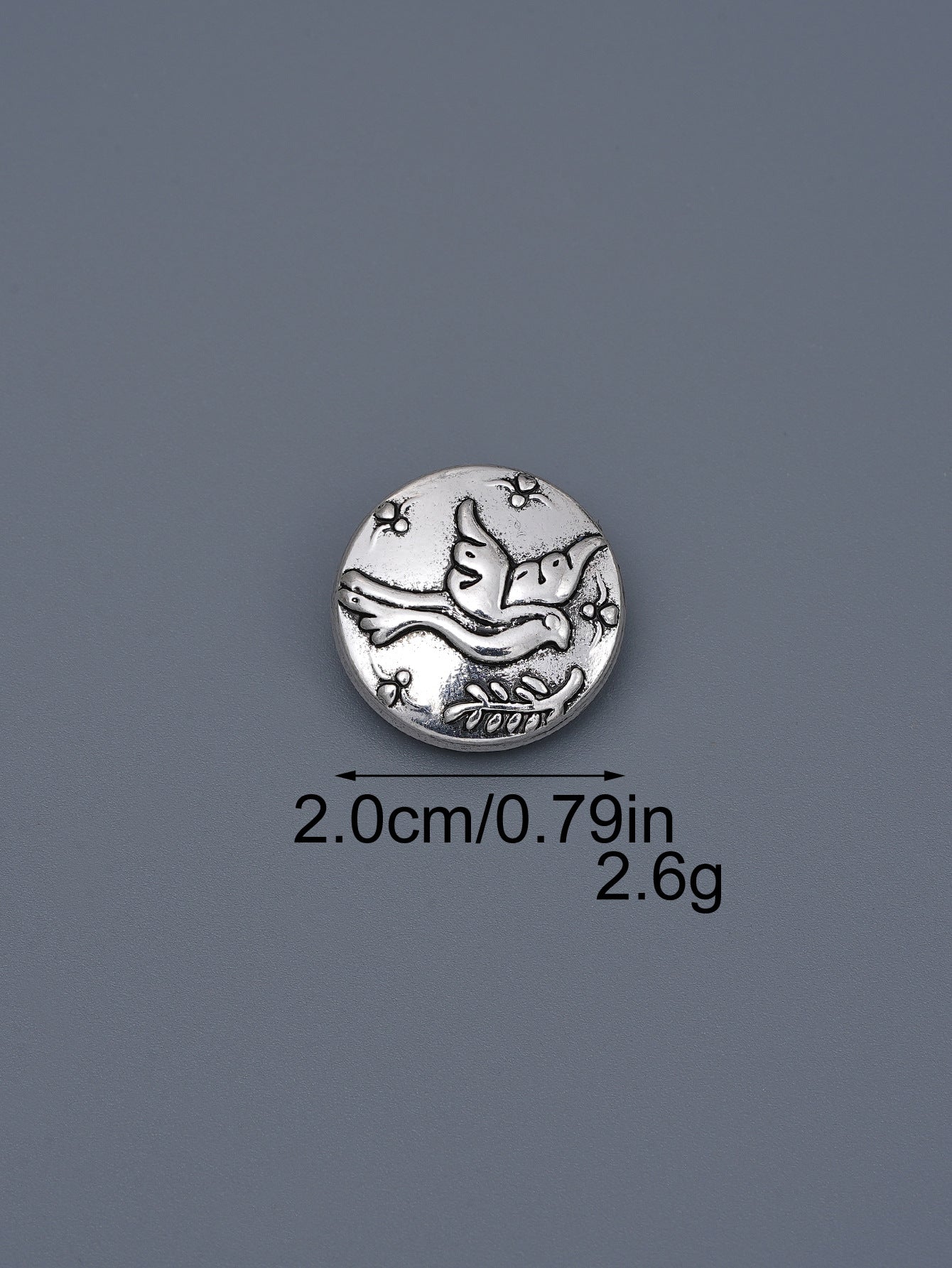Silver-toned embossed metal shank button with flying bird design, ~2.0cm