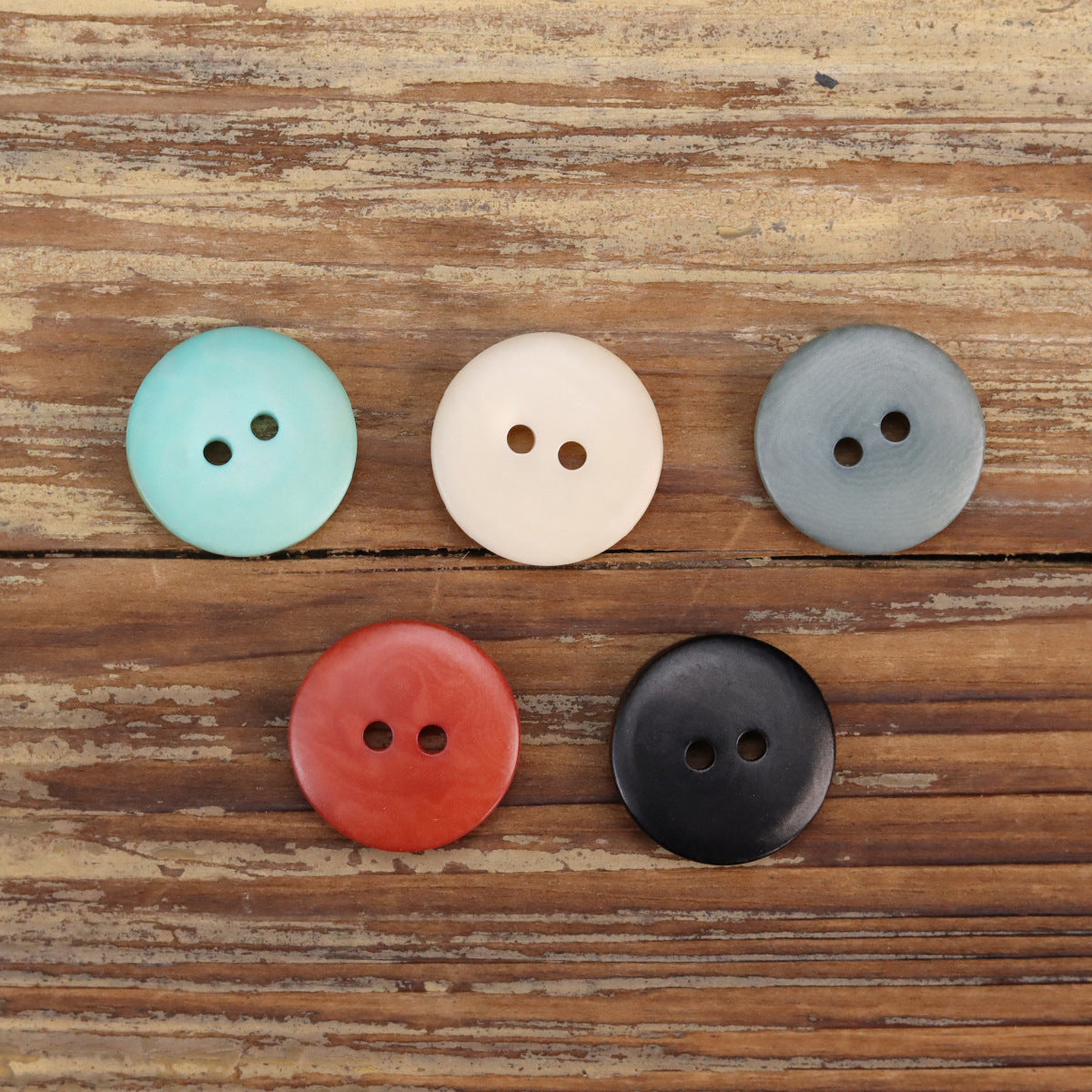 Round 2-hole buttons in turquoise, cream, blue-gray, red, and dark navy