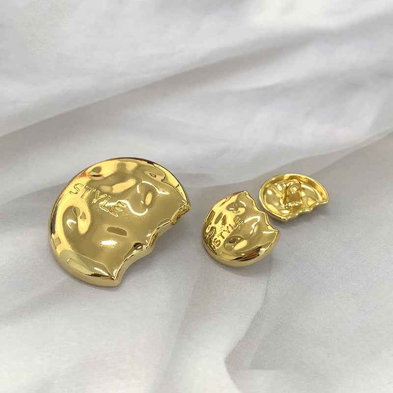 Gold semi-circular metal shank buttons, one front view and one with underside shank