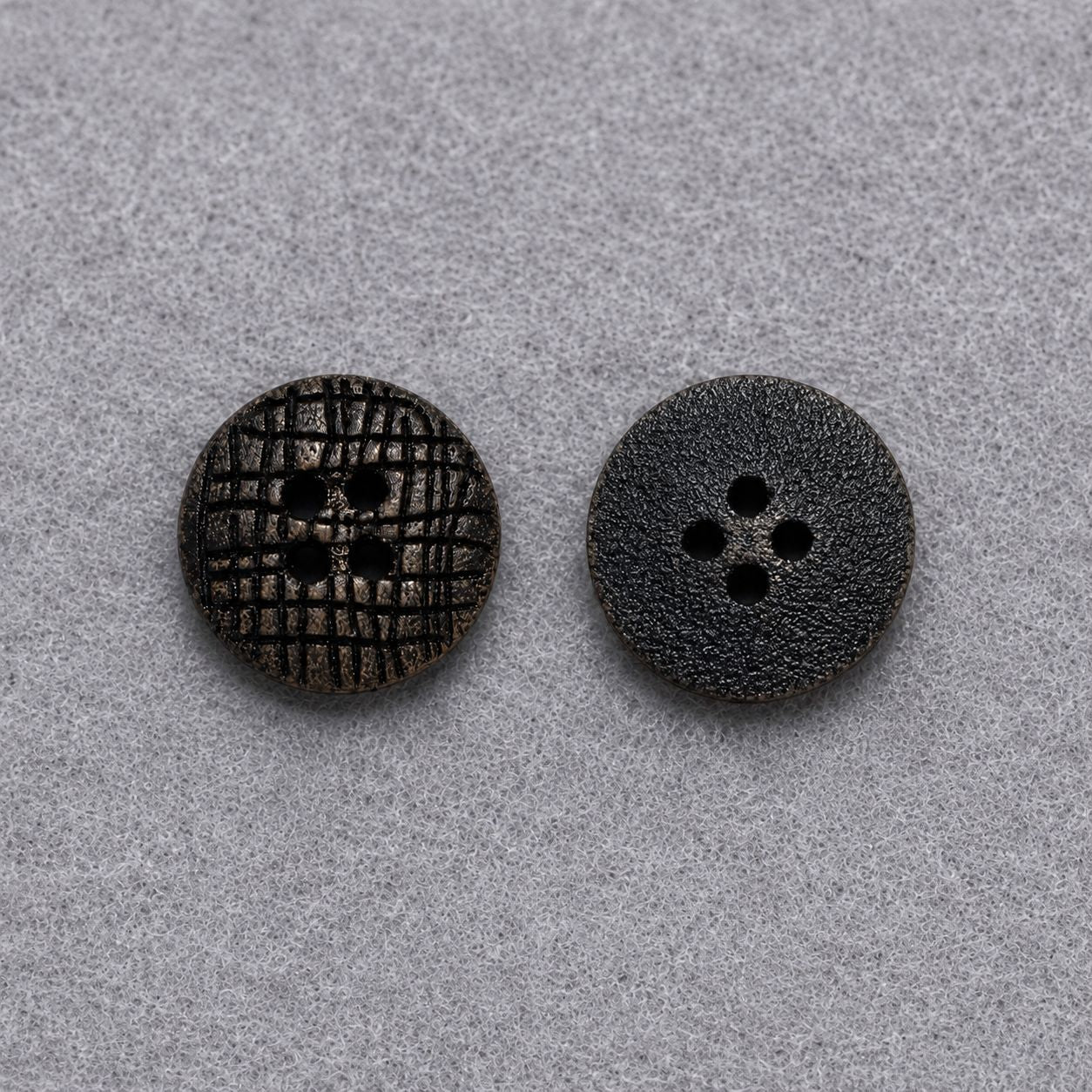 Two dark brown flat round wood buttons with four-hole designs