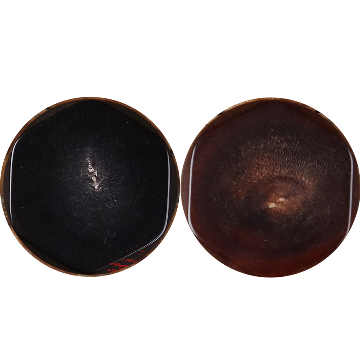 Two buffalo horn buttons: one dark, one dark brown, each with irregular edge