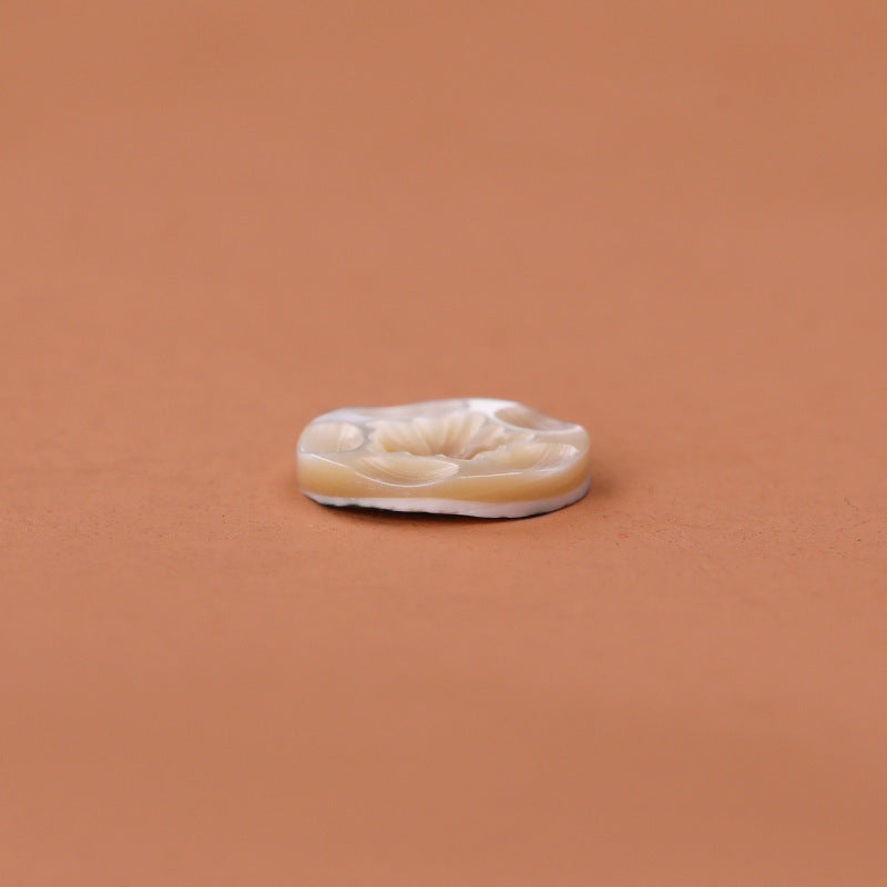 Side view of natural shell button with 2-hole base, beige tone, 11.5mm