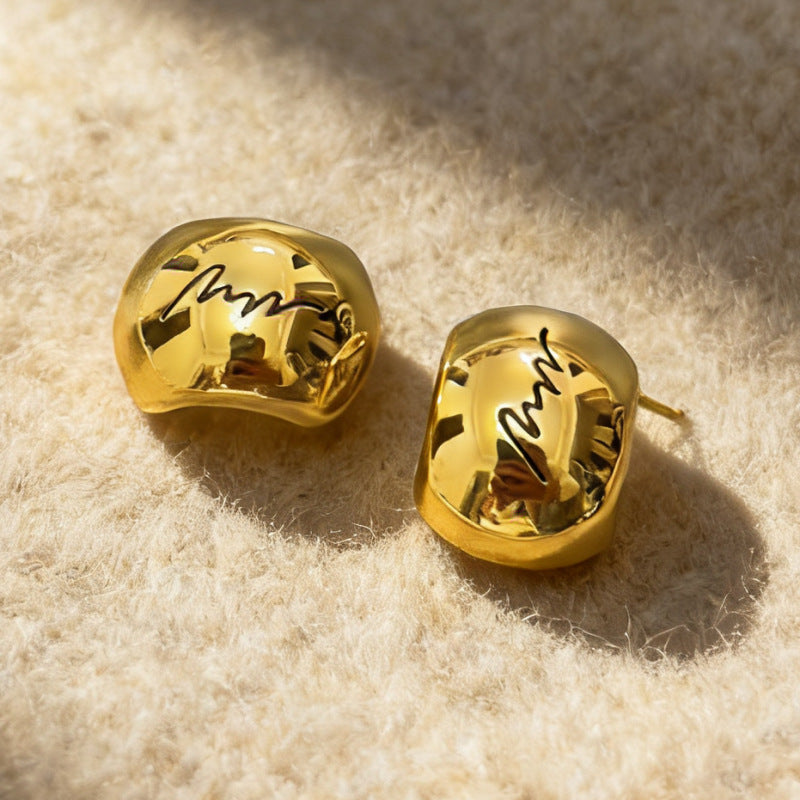 Gold arched monogram metal buttons with engraved letter detail