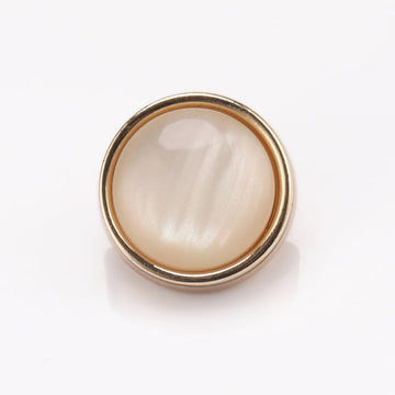 Cat-eye stone button with metal frame, shiny light gold rim and pearly white center