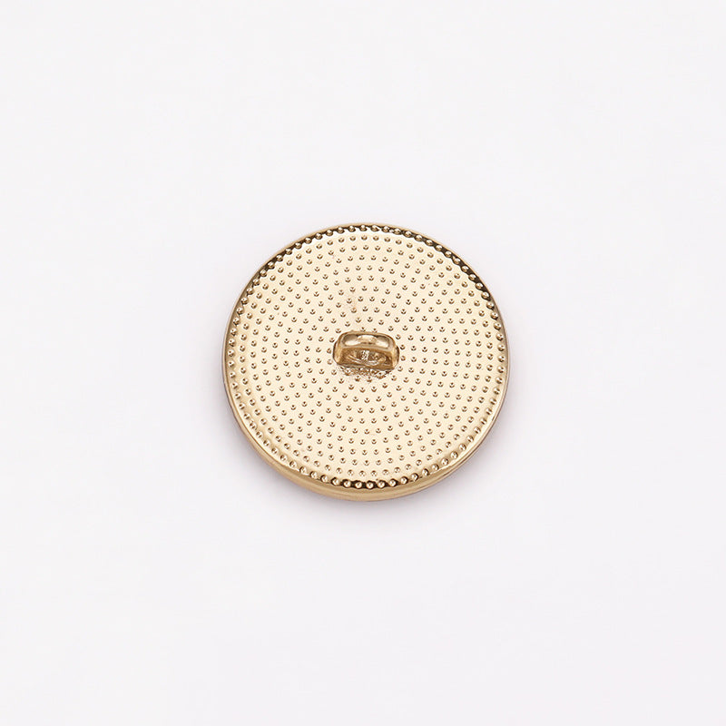 Light gold spiral concave metal shank button with dotted texture and center loop