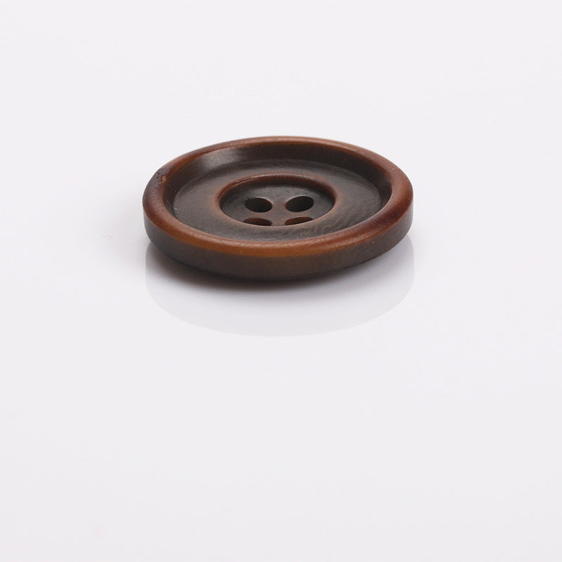 Brown two-tone round sewing button with four holes and dark inner face