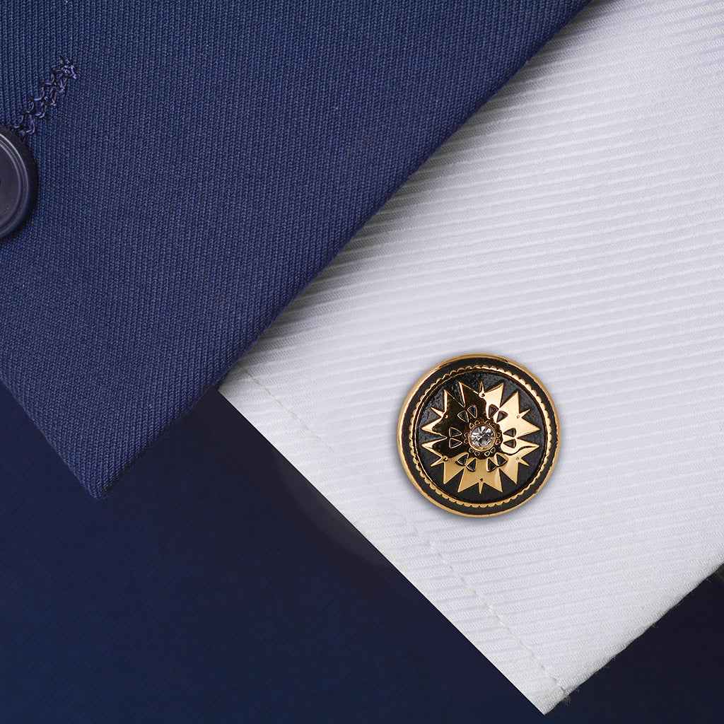 Black enamel gold round cufflink with crystal starburst, shown on shirt cuff