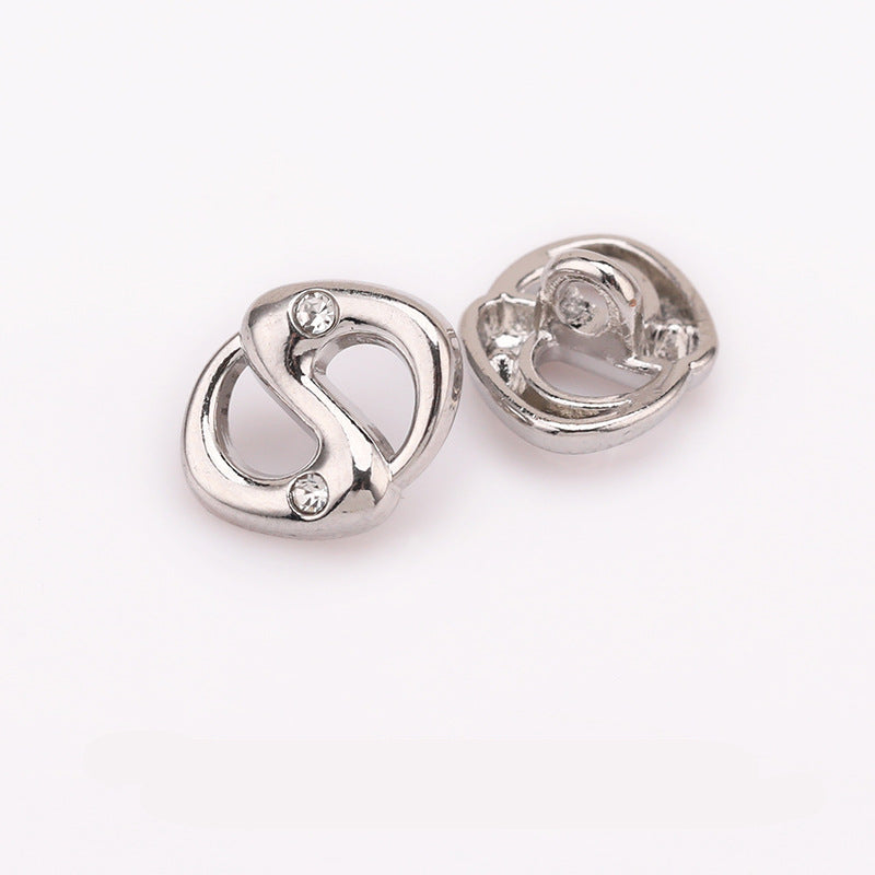 Silver-tone pig-nose rhinestone shank button, front with clear stones and back underside