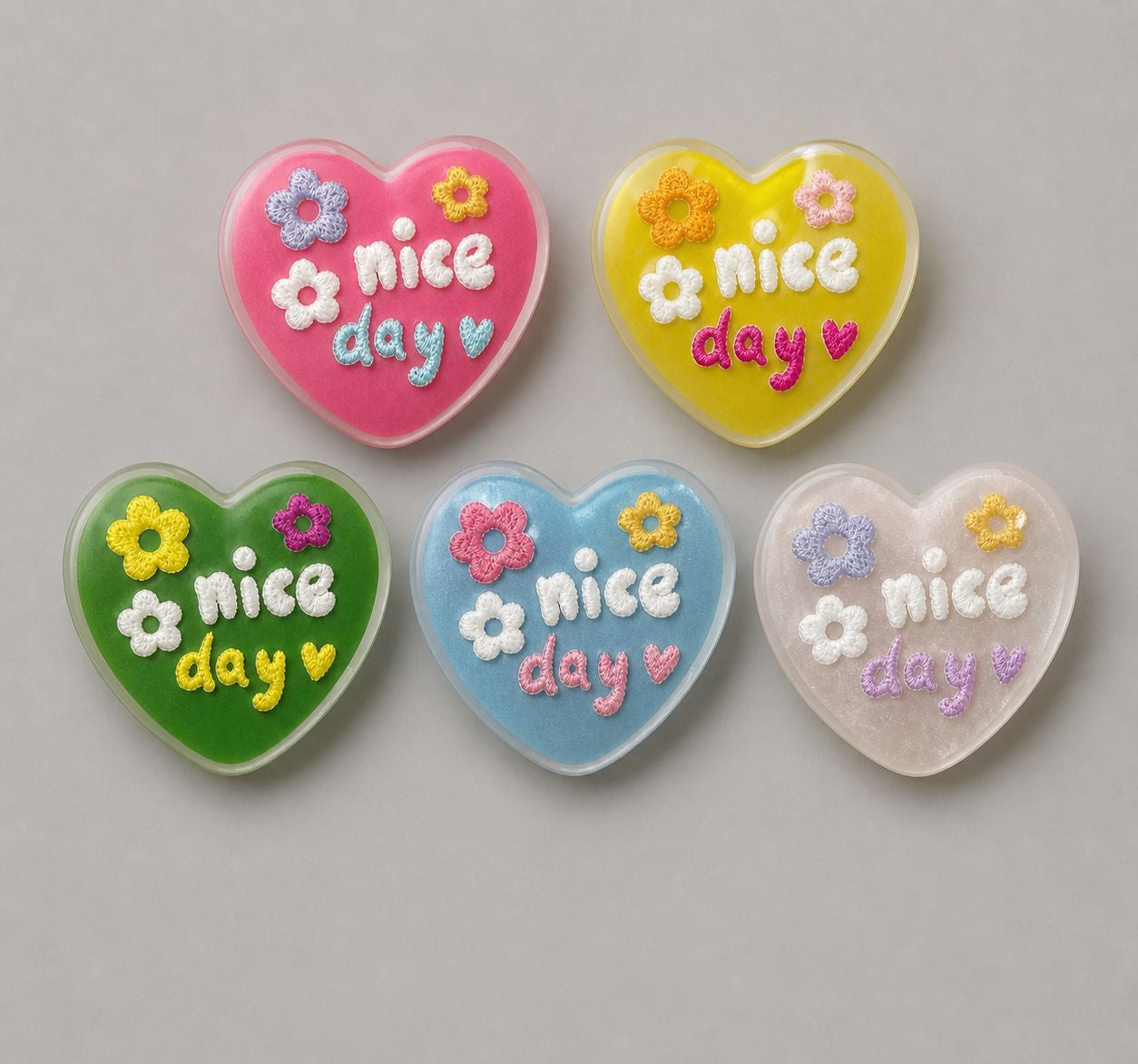 Heart-shaped resin buttons set in pink, yellow, green, blue, and light purple
