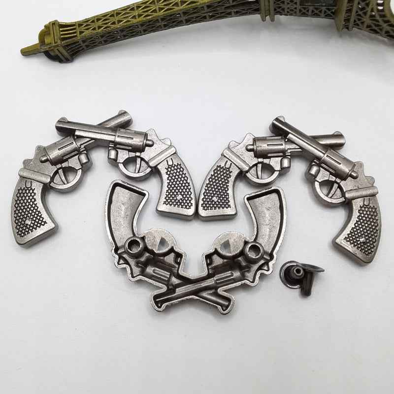 Antique silver double gun rivet studs with pistol motif, punk hardware