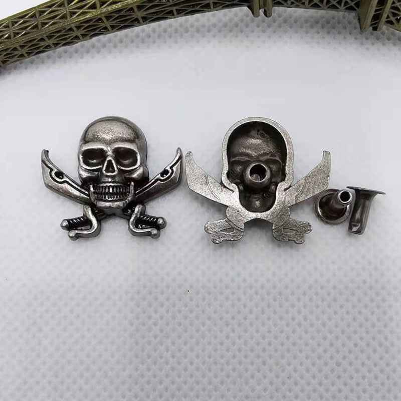 Metal skull rivet studs with dagger crossbones, silver-tone set of four