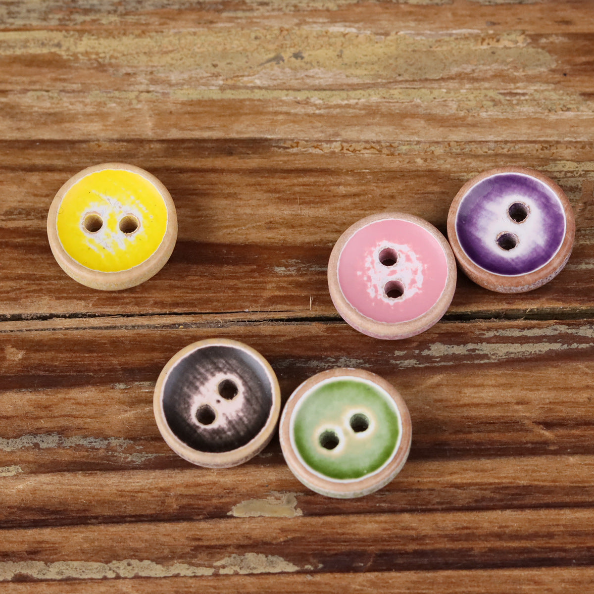 Assorted round iridescent wood buttons, yellow purple pink green, two holes