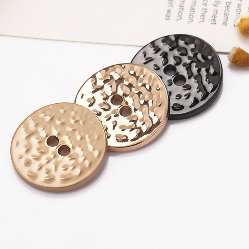 Textured 2-hole metal buttons in sand gold, gold and black stippled pattern
