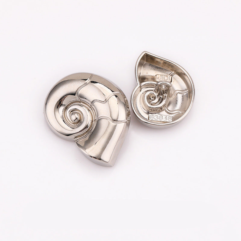 Snail-shaped metal shank button, nickel silver finish with spiral detail