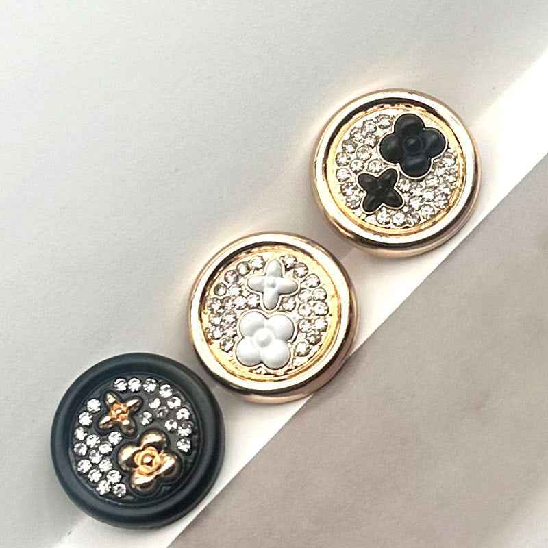 Round two-tone metal shank buttons, white clover detail on rhinestone field with gold edging