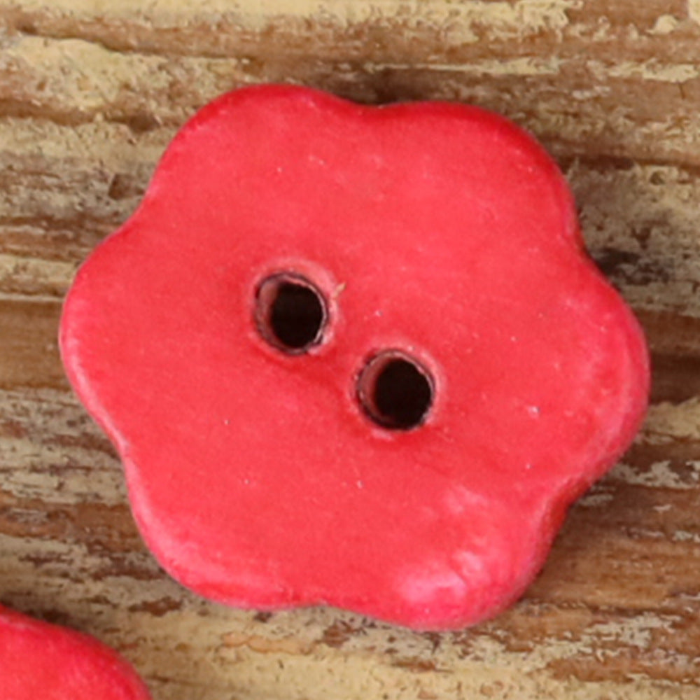 Red novelty shirt button with two holes on a rounded flower shape
