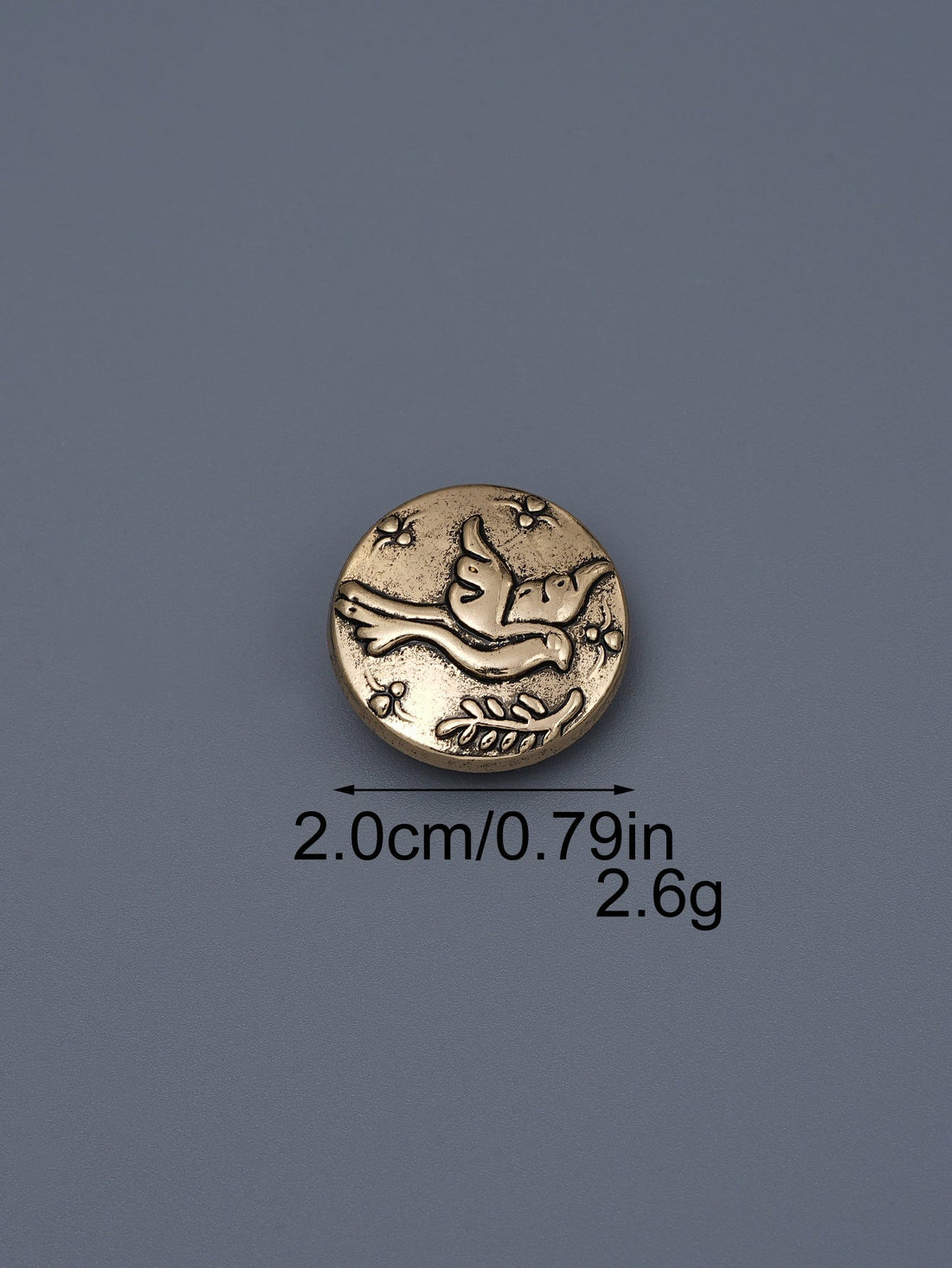 Silver-toned embossed metal shank button with flying bird design, ~2.0cm