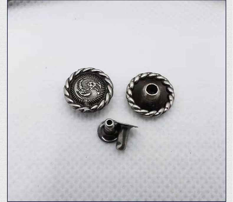 Round floral scroll rivet stud, showing front cap, back socket, and pointed post.