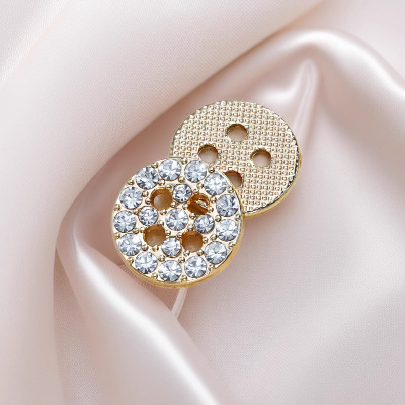 Gold round rhinestone 4-hole shirt button on fabric, crystal-studded front