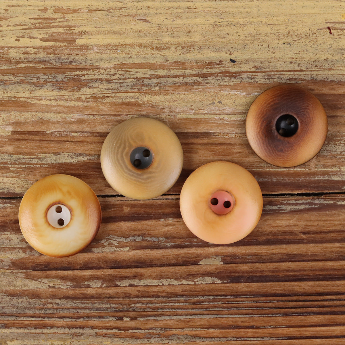 Assorted round two-hole seed buttons in tan, light wood, and dark brown