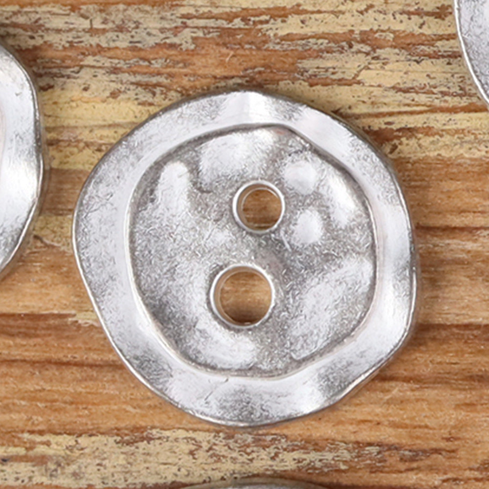 Bronze metal 2-hole button, irregular round face with two holes, textured finish.