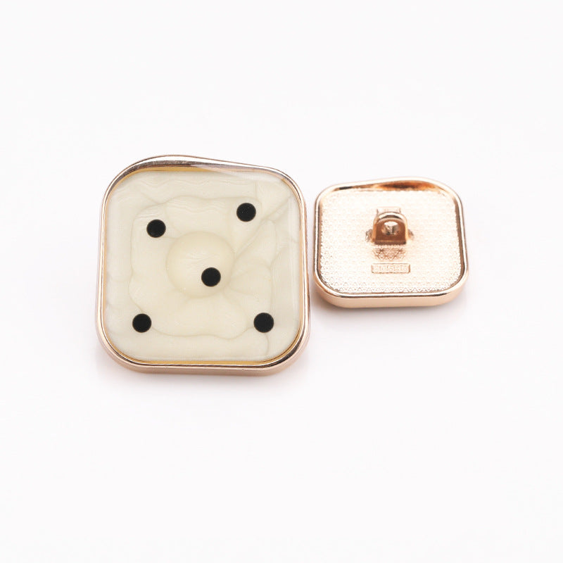 Cream marble square shank button with black dot design, gold metal frame