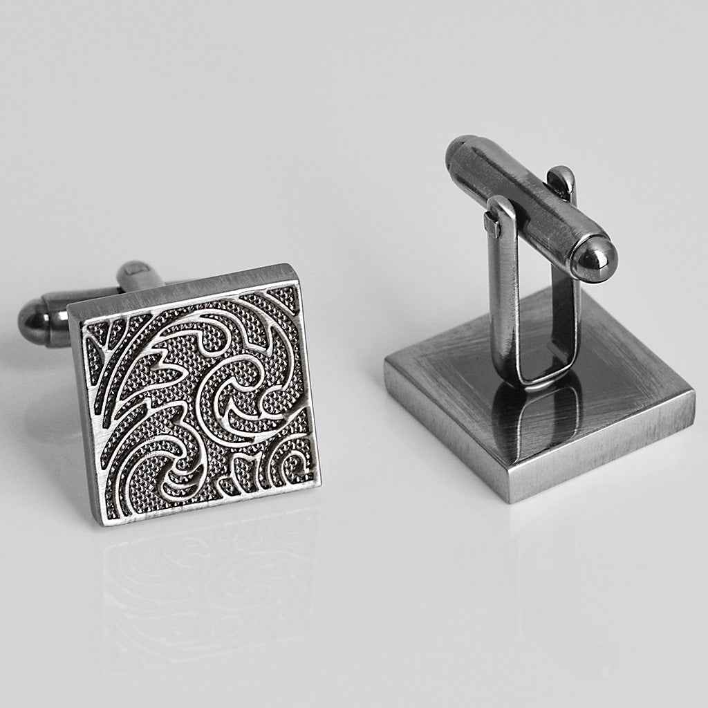 Antique silver square cufflinks with vintage scroll pattern on the front