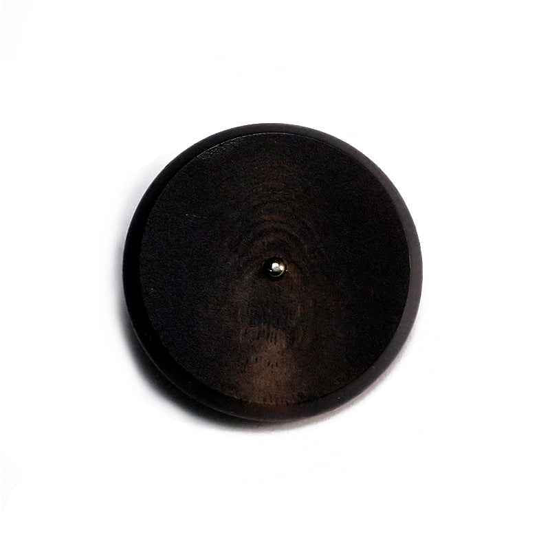 Dark black round resin button with flat face and metal shank, visible button post