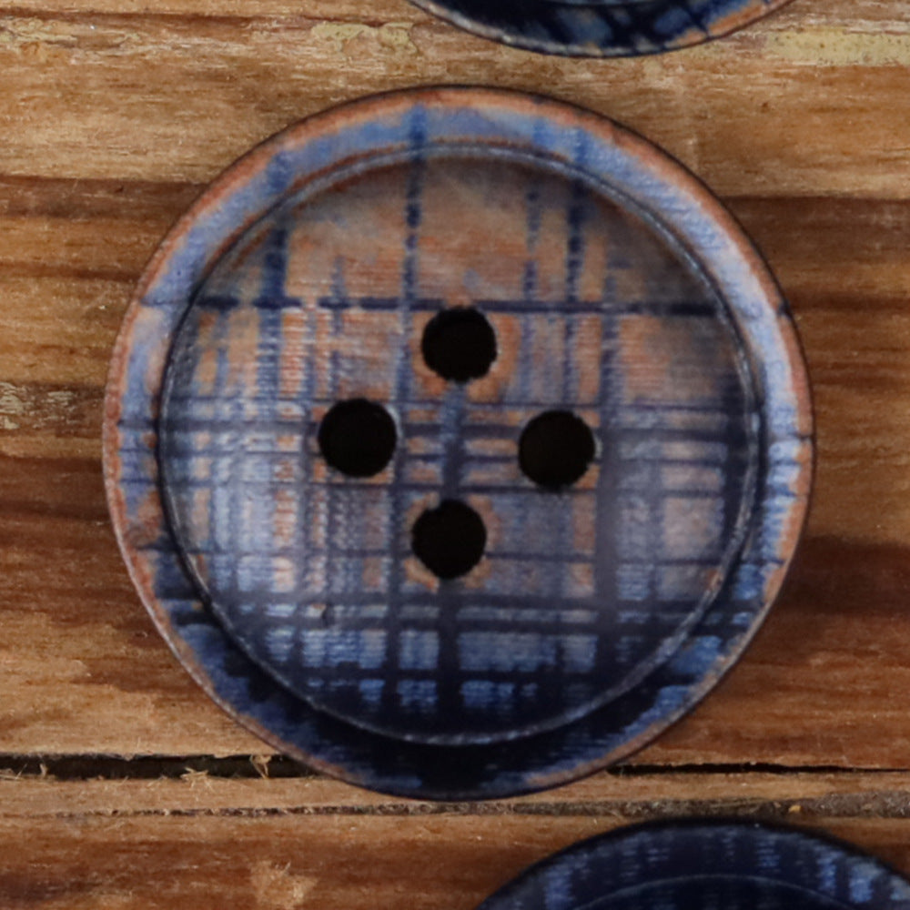 4-hole round button close-up, blue plaid fabric with four black holes