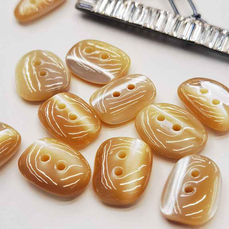 Irregular mother-of-pearl shell buttons, orange with white marbled lines, 2 holes