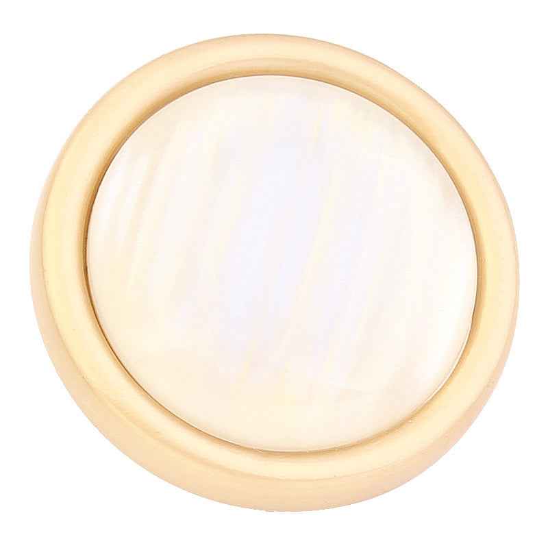 White cat’s eye shank button close-up, gold rim and round opal-like face