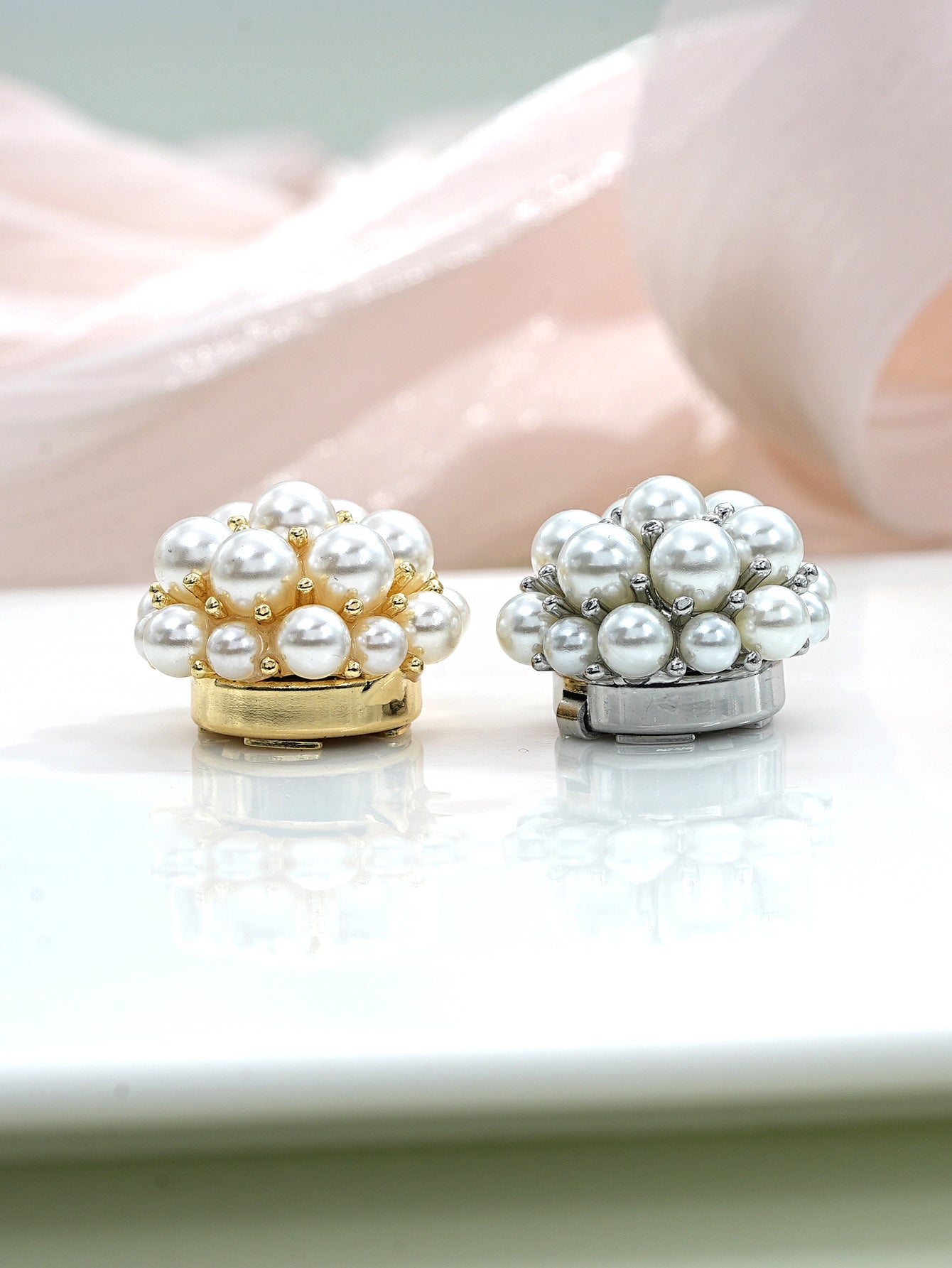 Pearl flower metal clamp buttons, side profile showing round pearl dome and base.