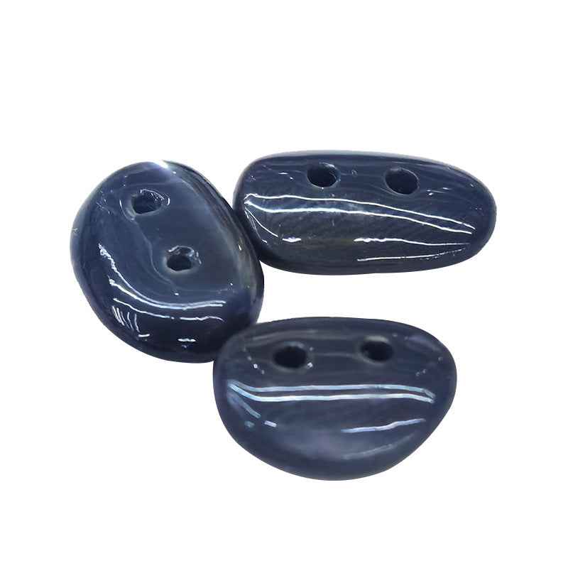 Irregular mother-of-pearl shell buttons, dark blue/black with white veining, two holes