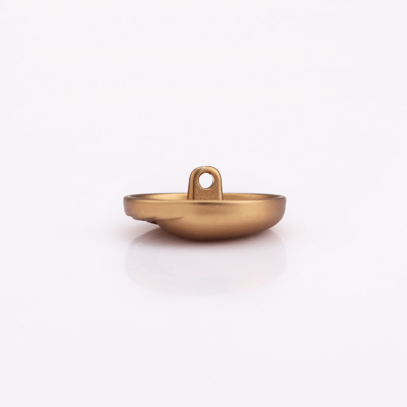 Light gold round metal shank button, edge view showing shank attachment loop