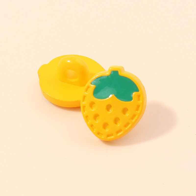 Yellow strawberry-shaped plastic shank button with green leaf and round dot holes